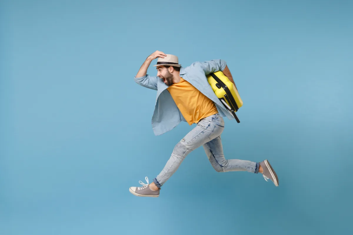 Happy traveler with suitcase enjoying hands-free exploration after storing luggage with BagsAway
